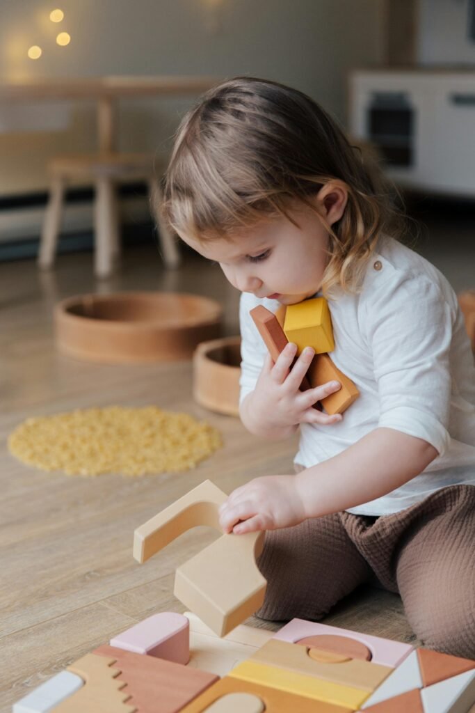 Child playing with wooden educational toys